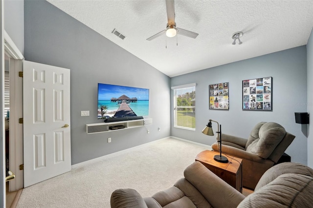 carpeted living room featuring vaulted ceiling, ceiling fan, and a textured ceiling