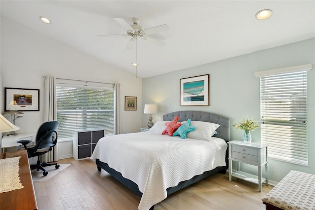 bedroom with ceiling fan, lofted ceiling, and light hardwood / wood-style flooring