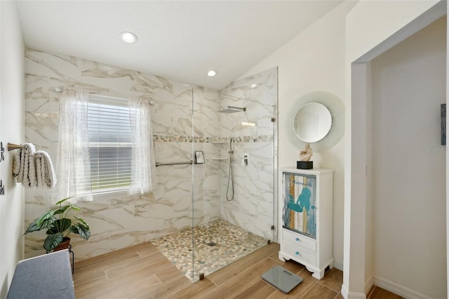 bathroom featuring lofted ceiling and a shower with door