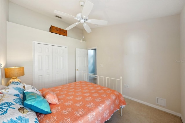 bedroom with vaulted ceiling, carpet flooring, ceiling fan, and a closet