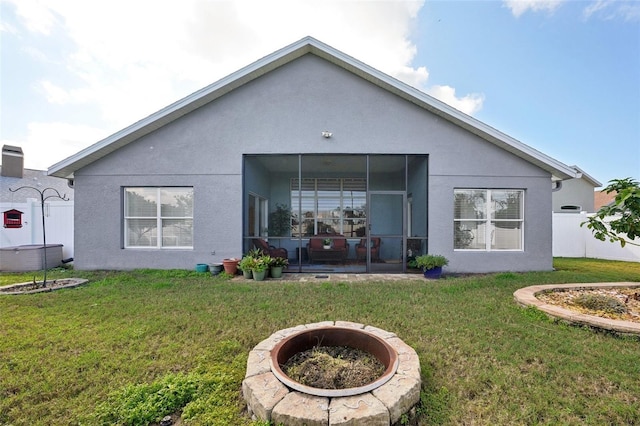 rear view of house featuring a lawn