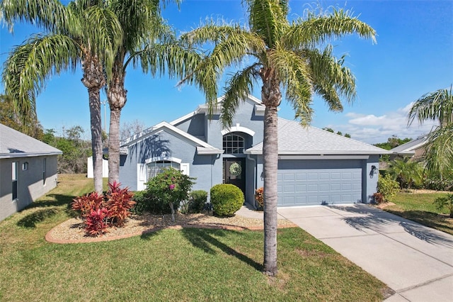 view of front facade featuring a garage and a front yard