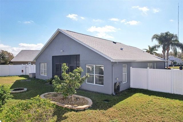 rear view of property with a lawn