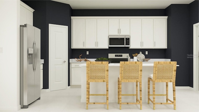 kitchen featuring white cabinetry, stainless steel appliances, and a kitchen breakfast bar