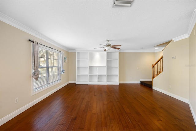 unfurnished living room with crown molding, ceiling fan, dark hardwood / wood-style floors, a textured ceiling, and built in shelves