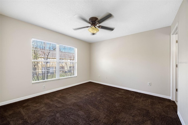 carpeted spare room with ceiling fan and a textured ceiling