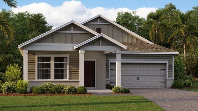 view of front of property with a garage and a front lawn