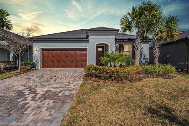 view of front facade with a garage and a lawn