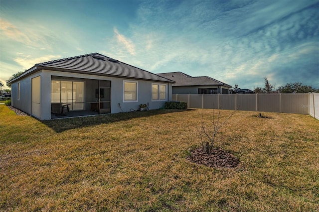 back of property featuring a lawn