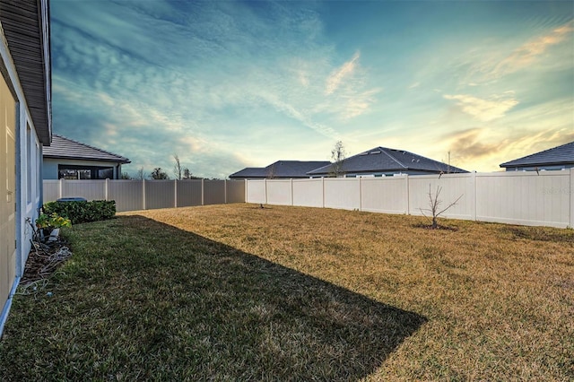 view of yard at dusk