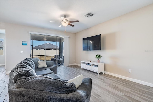 living room featuring ceiling fan and light wood-type flooring