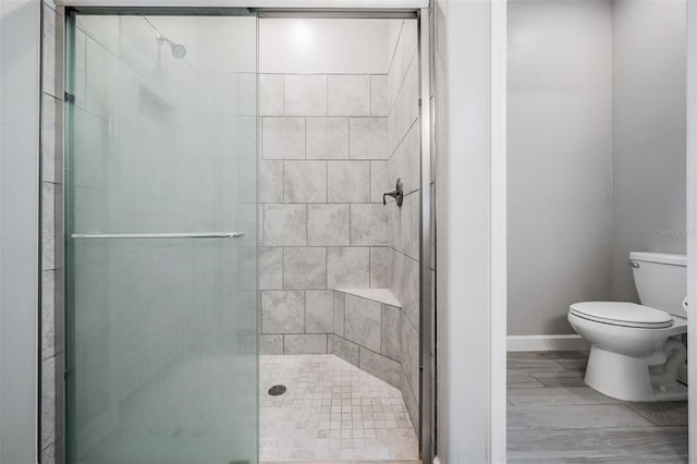 bathroom with walk in shower and toilet