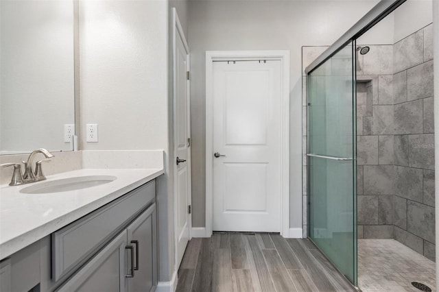 bathroom featuring vanity and an enclosed shower