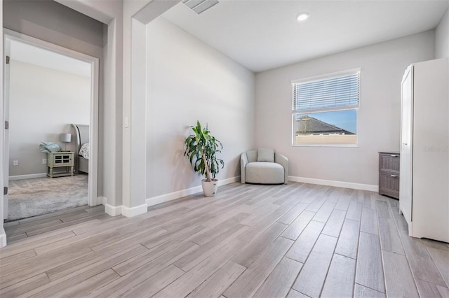 unfurnished room featuring light hardwood / wood-style floors