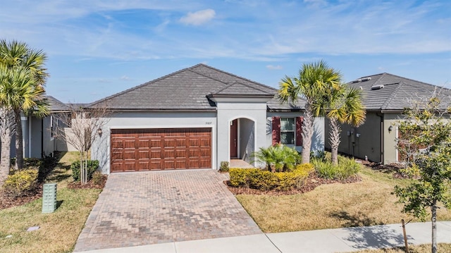 single story home featuring a garage and a front lawn