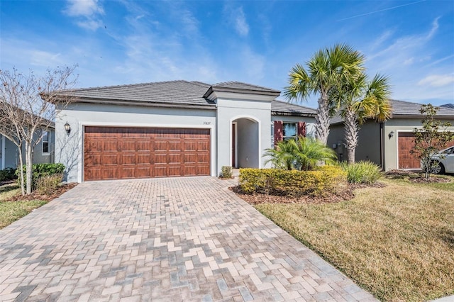 view of front of property with a garage and a front lawn