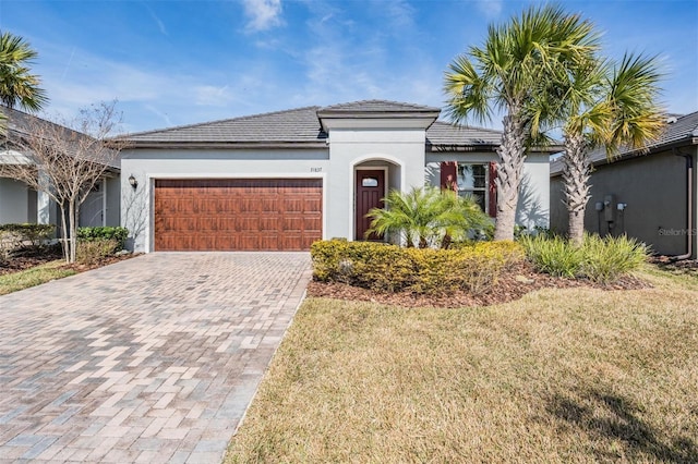 view of front of home with a garage and a front yard