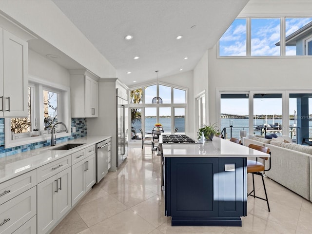 kitchen with white cabinetry, dishwasher, and a water view