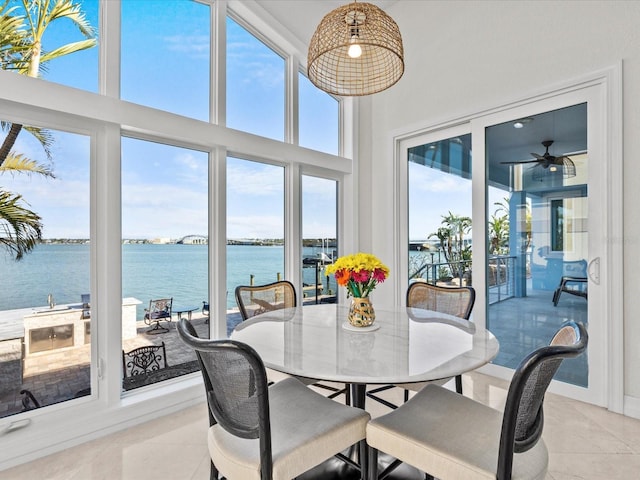 sunroom / solarium featuring a water view