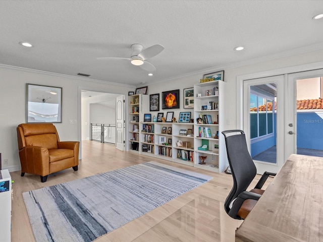 office area featuring french doors, ornamental molding, and a textured ceiling