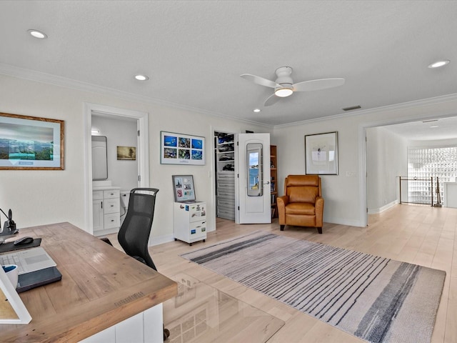 home office with ornamental molding, ceiling fan, a textured ceiling, and light hardwood / wood-style floors