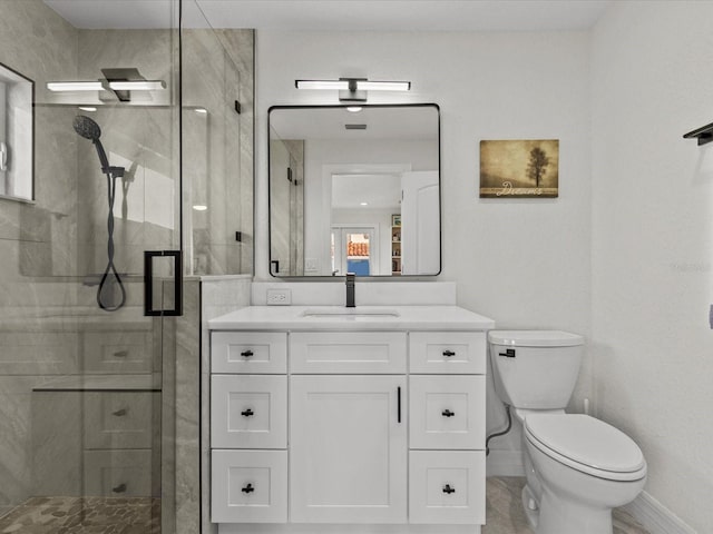 bathroom featuring vanity, an enclosed shower, and toilet