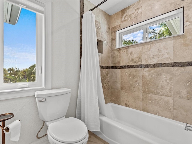 bathroom featuring toilet and shower / bath combo with shower curtain