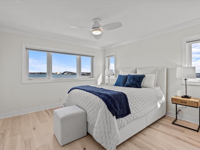 bedroom featuring crown molding, a water view, ceiling fan, and light hardwood / wood-style flooring