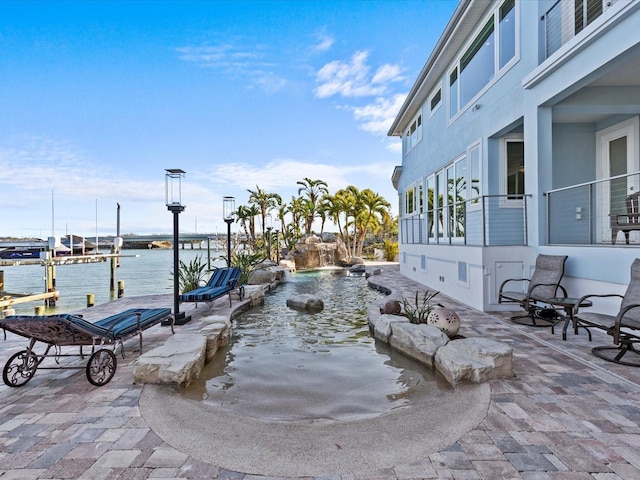 exterior space with a boat dock and a water view