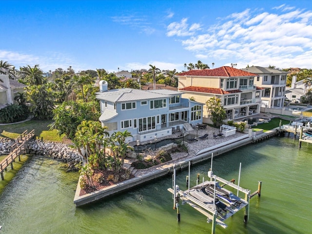 view of dock featuring a patio area and a water view