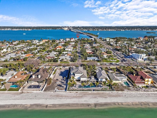 birds eye view of property with a water view and a beach view