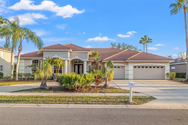 mediterranean / spanish home with french doors and a garage