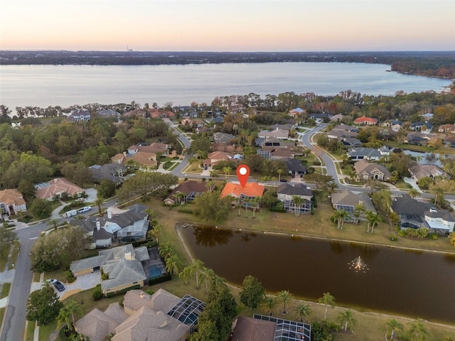 aerial view at dusk with a water view