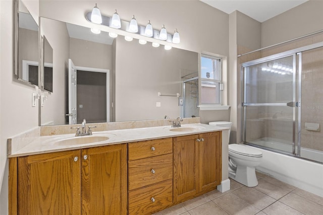 full bathroom with tile patterned flooring, enclosed tub / shower combo, vanity, and toilet