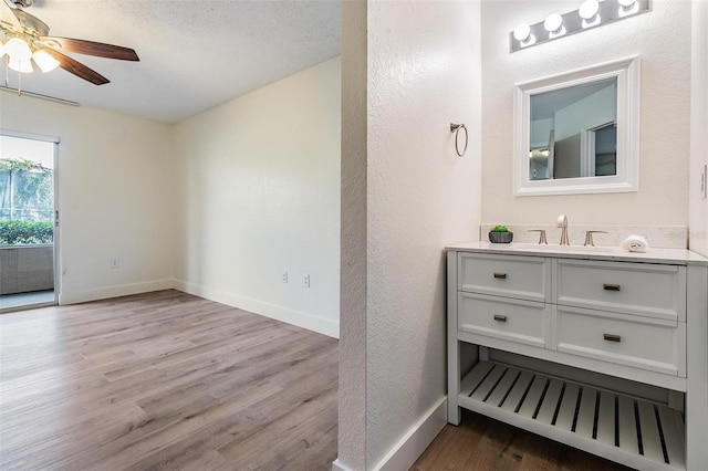 bathroom with vanity, wood-type flooring, and ceiling fan