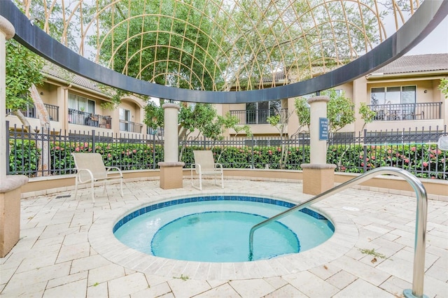 view of pool with a hot tub and a patio