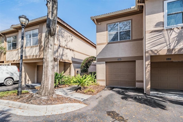 multi unit property featuring a garage