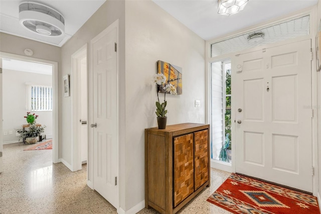 entryway featuring light speckled floor and baseboards