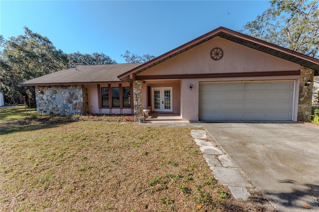 single story home featuring a garage, a front lawn, and french doors