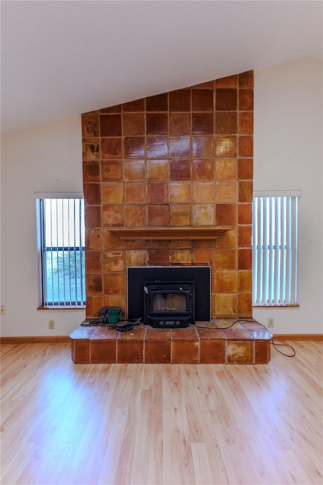 room details with hardwood / wood-style flooring and a large fireplace