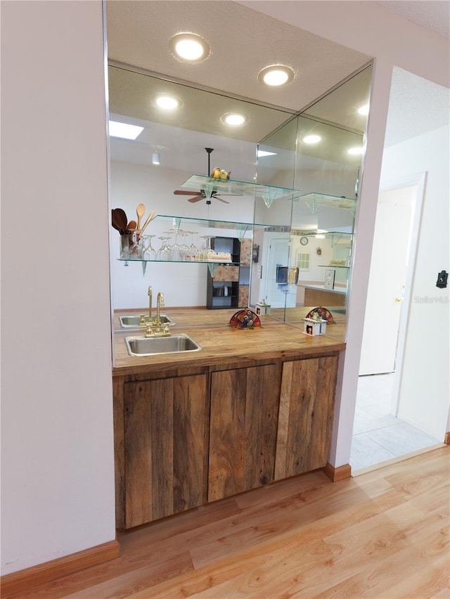 kitchen with sink, hardwood / wood-style flooring, and ceiling fan