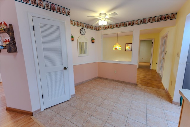 empty room featuring ceiling fan and light tile patterned floors