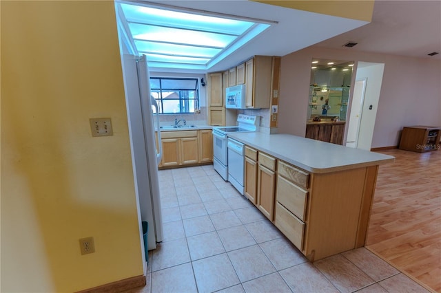 kitchen with light tile patterned floors, white appliances, light brown cabinetry, decorative backsplash, and kitchen peninsula