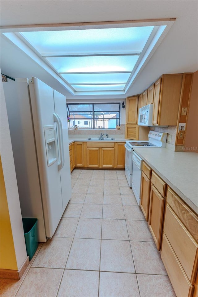 kitchen featuring sink, white appliances, and light tile patterned floors