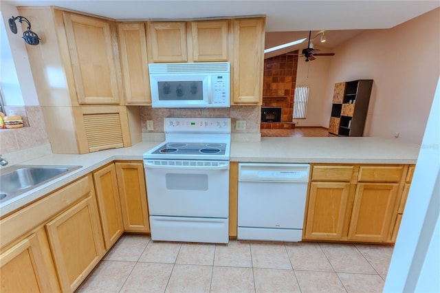 kitchen featuring tasteful backsplash, light tile patterned floors, ceiling fan, kitchen peninsula, and white appliances