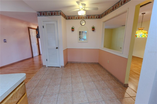 tiled empty room with ceiling fan