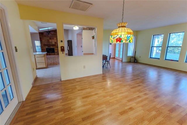 interior space with a large fireplace and light hardwood / wood-style flooring