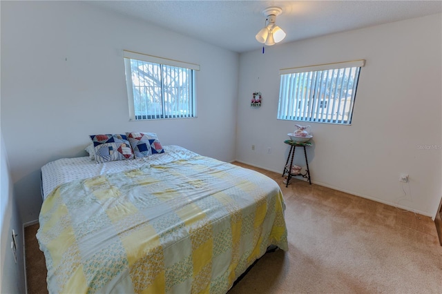 bedroom with carpet floors and multiple windows