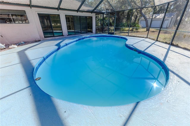 view of swimming pool with glass enclosure