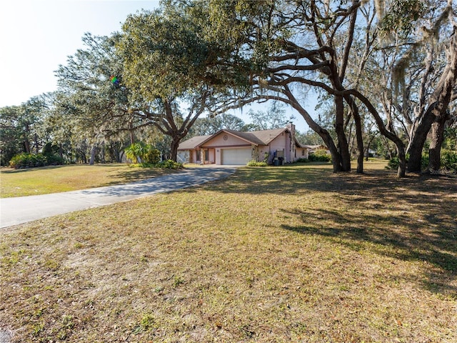 view of front of property with a garage and a front yard